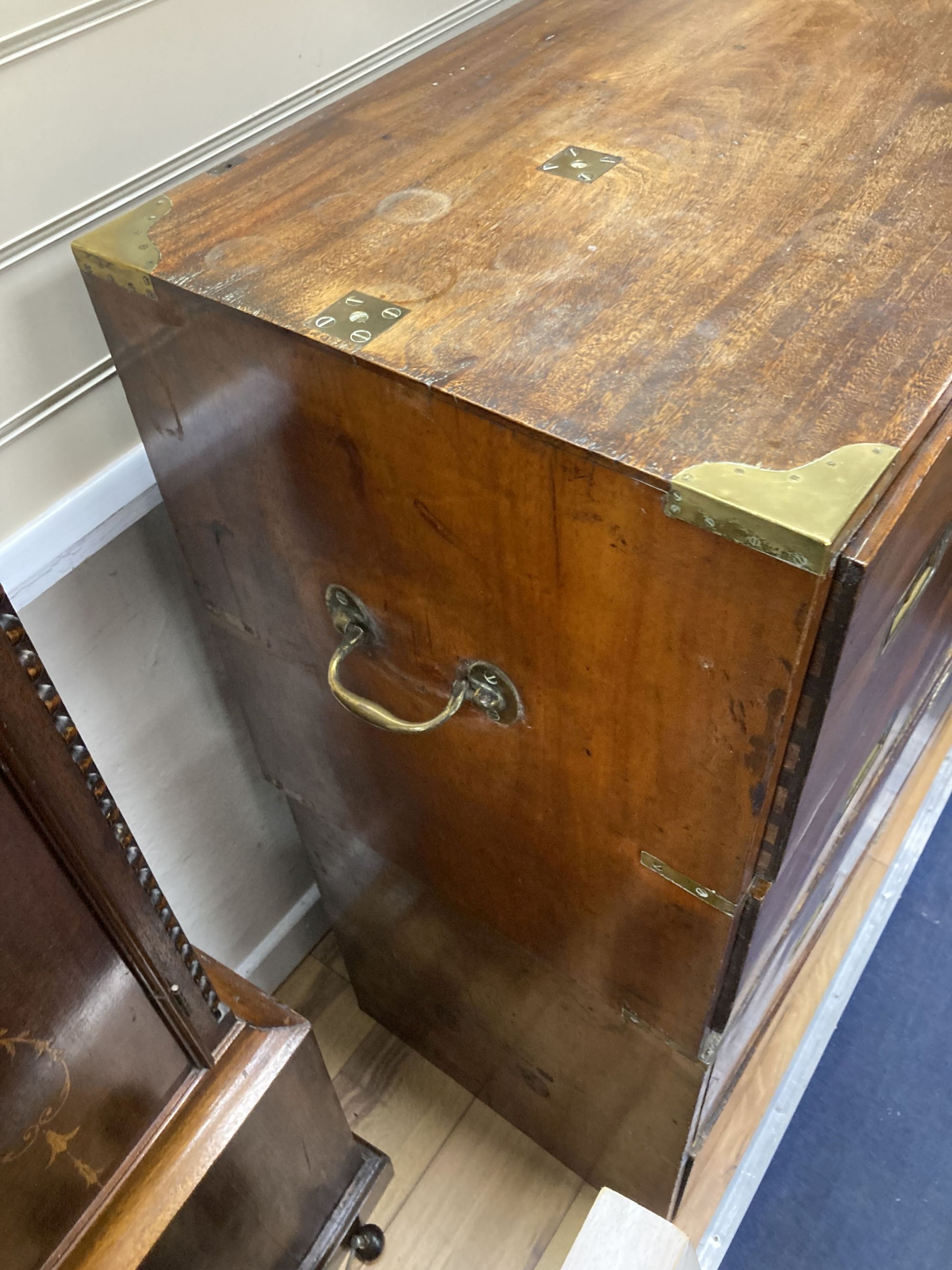 A 19th century brass mounted teak two part military chest (lacking one drawer) width 97cm, depth 46cm, height 107cm